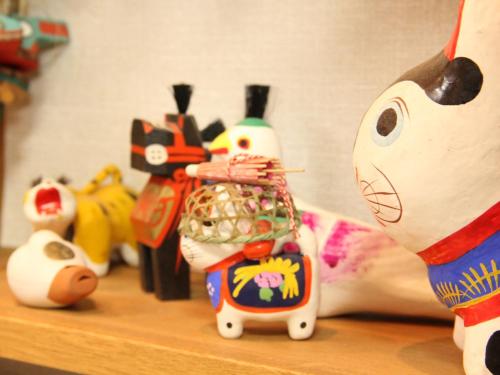 a group of toy animals sitting on a shelf at Hatoguruma Kawabata in Nozawa Onsen