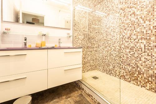a bathroom with white cabinets and a shower at Le Syrius in Nice
