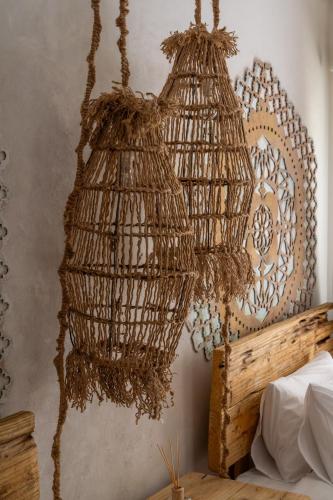 a rattan bird cage hanging from a wall at Art Cabin At The Beach in Langstrand