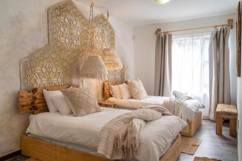 a bedroom with two beds and a large window at Art Cabin At The Beach in Langstrand