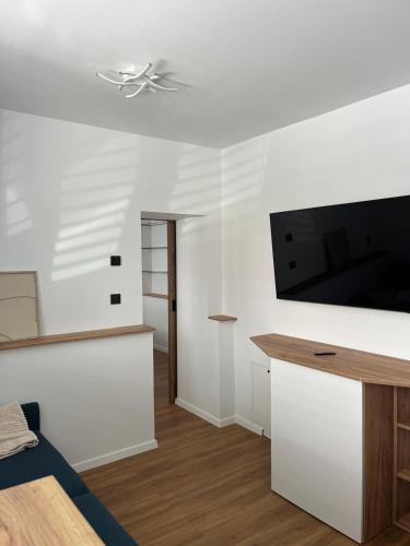 a living room with a flat screen tv on a wall at IQ Apartments in Prešov