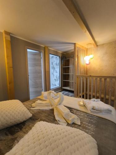 a bedroom with two beds with towels on them at Paradise and Love Room in Haguenau