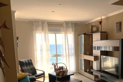 a living room with a large window and a chair at Appartamento Sinestesia Oceanica in Puerto del Rosario