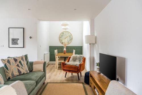 a living room with a couch and a table at Arch Row Cottage - Stow on the Wold in Stow on the Wold