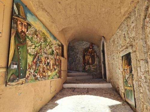 a hallway with paintings on the walls of a building at Portella delle Fate in Sora