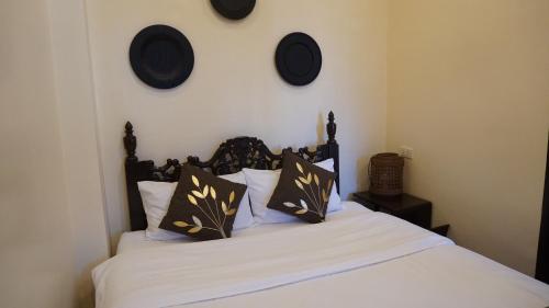 a bedroom with a bed with white sheets and pillows at Park Avenue Boutique Hotel Manila in Manila