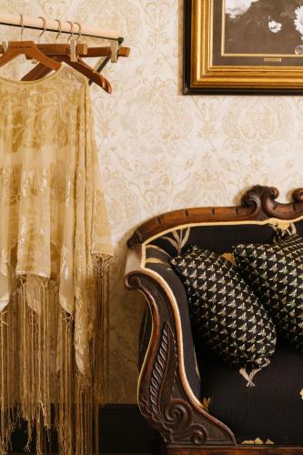 a room with a couch with curtains and a picture at Sotto I Sassi in Guiglia
