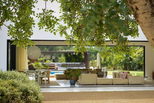 a living room with couches and a pool at Villa Can Pep de Sa Guaita Amaizing Design & Outdoor Area 10 minutes from beaches Calm Area in Ibiza Town