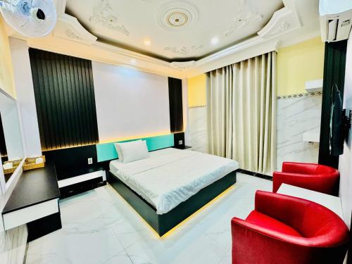 a bedroom with a bed and two red chairs at 168 Hotel in Ho Chi Minh City