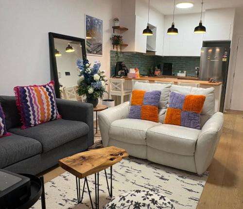 a living room with a couch and a table at “Urban Oasis ” Central emporium apt ,Free Parking in Melbourne