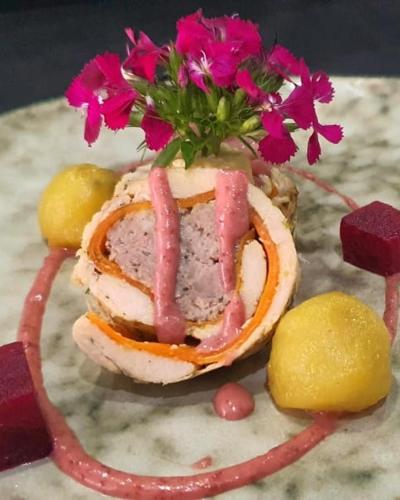 a sandwich with ham and flowers on a plate at Palala Boutique Game Lodge and Spa in Tom Burke