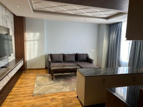 a living room with a couch and a table at The Grand Mamta in Srinagar