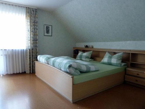 a bedroom with a large bed with blue and white pillows at Ferienwohnungen Hiemer in Lindau