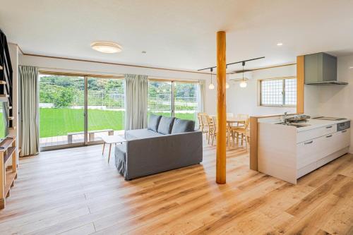 a kitchen and living room with a couch and a table at 三浦海岸 SeaLightVilla B棟 in Miura