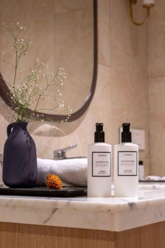 two bottles ofodorizers on a counter in a bathroom at The Magnus in Coimbatore