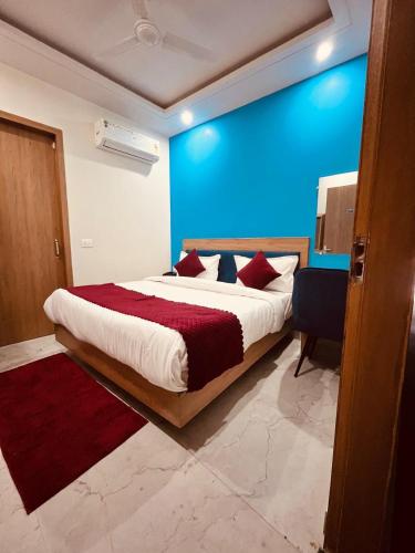 a bedroom with a large bed with red pillows at Hotel The Rise At Delhi Airport in New Delhi
