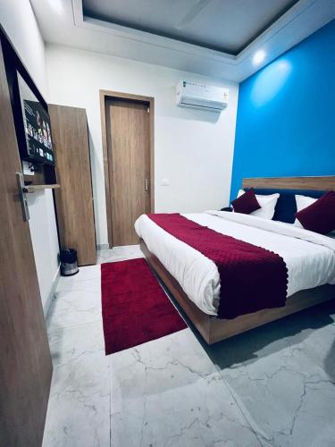 a bedroom with a large bed and a red rug at Hotel The Rise At Delhi Airport in New Delhi