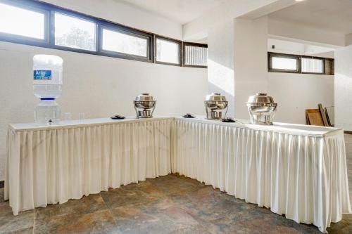 a room with a table with a white curtain at Collection O Golden Leaf in Pune
