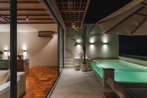 a pool in a room with at Sore Escape Tumbak Bayuh by Betterplace in Tumbak Bayuh