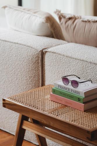 two books sitting on a table next to a couch at Sore Escape Tumbak Bayuh by Betterplace in Tumbak Bayuh