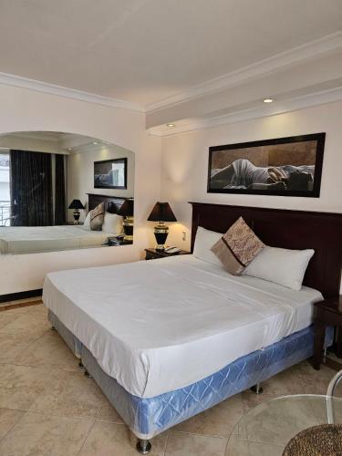 a large bedroom with a large bed in it at Valentino's Hotel in Angeles