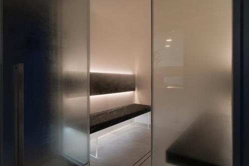 a glass door with a shelf in a room at Il Marchese Hotel & Spa in Sciacca