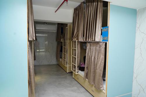 a room with a closet with curtains on it at City Dormitory in Ahmedabad