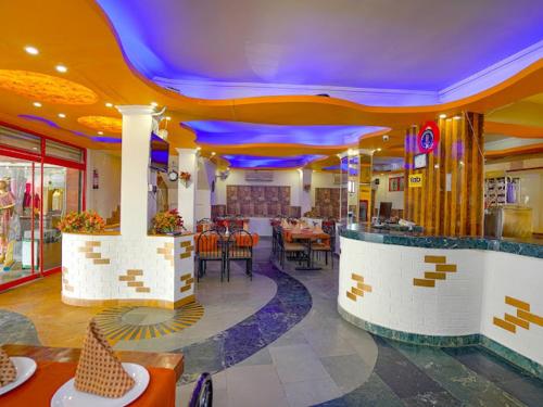 a restaurant with tables and chairs in a building at Hotel 24x7 Inn Jalandhar in Jalandhar