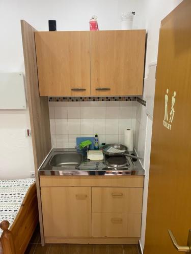 a small kitchen with a sink and a stove at Zimmervermietung Ausspannen bei Fam Pertiller in Breese