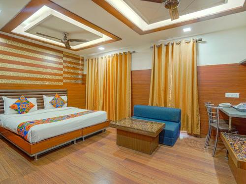 a bedroom with a bed and a table and a chair at Hotel 24x7 Inn Jalandhar in Jalandhar