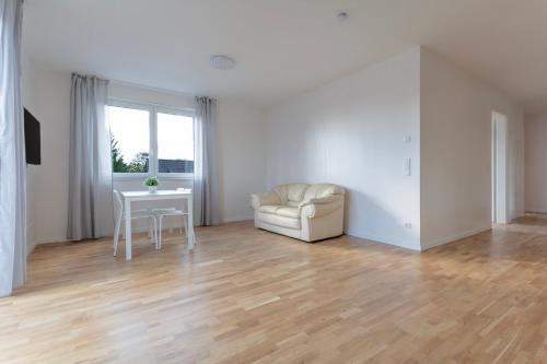 a living room with a chair and a table at T&K Apartments - BERGISCH GLADBACH - 7 Comfortable Apartments - 20 min to Fair Messe Cologne in Cologne