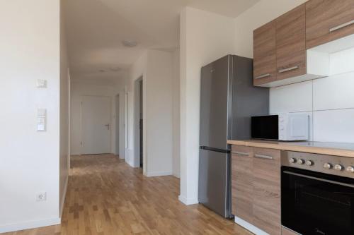a kitchen with a stove and a microwave at T&K Apartments - BERGISCH GLADBACH - 7 Comfortable Apartments - 20 min to Fair Messe Cologne in Cologne