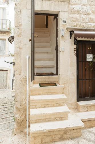 a set of stairs in front of a building at CALMAPIANTA home for green lovers in Putignano