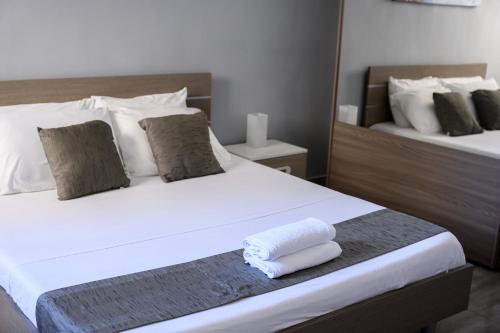 a bedroom with a bed with two towels on it at F9 Room 1, Private Double room with private bathroom in shared Flat in Msida