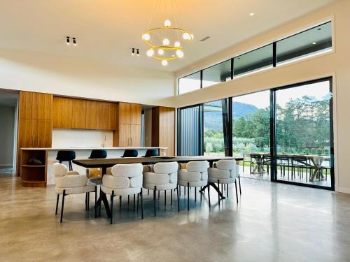 a large dining room with a table and chairs at Chris' - Designer Masterpiece In Kangaroo Valley in Kangaroo Valley