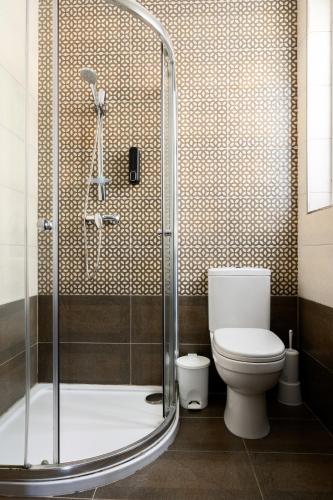 a bathroom with a toilet and a glass shower at F9 Room 1, Private Double room with private bathroom in shared Flat in Msida