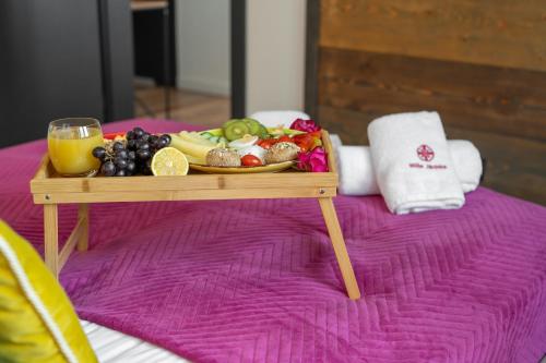 a tray of fruit on a table on a bed at WILLA JAROSTA & SPA, AC -free parking in Zakopane