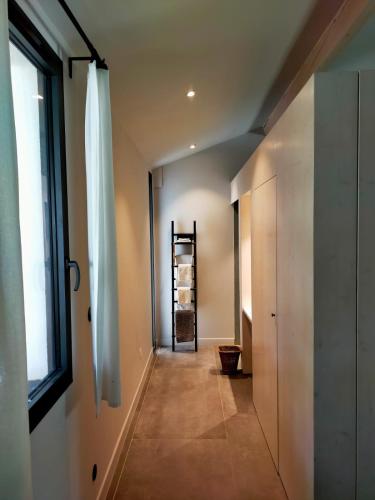 a hallway of a house with a window at Mas de charme au pied des Alpilles in Maussane-les-Alpilles