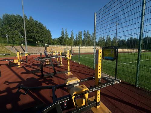 a fence with yellow dividers on a soccer field at Luxus Guest Suite & SAUNA Finnish design house in Espoo