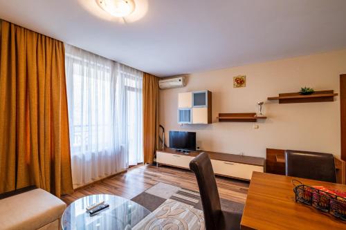 una sala de estar con un sofá y una mesa en Primrose Apartment with Free Parking, en Varna