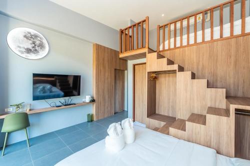 a bedroom with a bed and a staircase at Merbrisa Rayong poolvilla-Ao khai beachfront in Mae Pim
