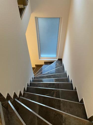 a staircase with a window in a building at ARYVE Boutique-Apartments in bester Lage in Bad Hersfeld in Bad Hersfeld