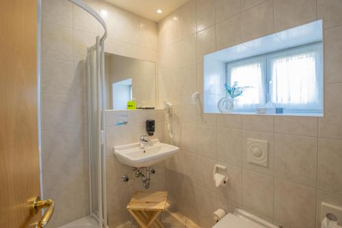 a bathroom with a sink and a toilet and a window at Ferien Residenz Thüringer Wald in Masserberg