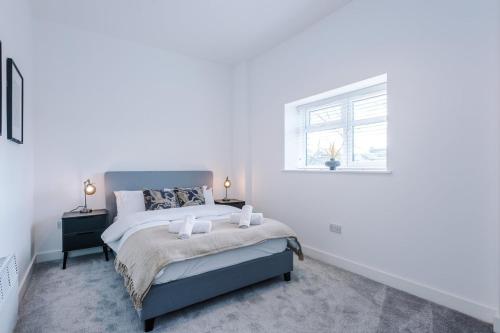 a white bedroom with a bed and a window at Modern 1BR Apartment in Central Warrington in Warrington