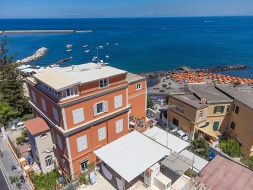a large building next to a body of water at Excelsior Mare Suite in Ischia