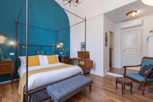 a bedroom with a bed and a blue wall at 900 - Guest House in Livorno