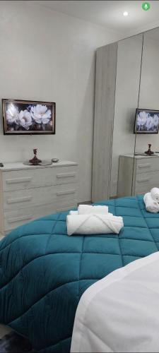 a bedroom with two beds with a blue blanket at b&b al lago Mady in Avigliana