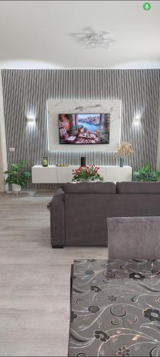 a living room with a couch and a flat screen tv at b&b al lago Mady in Avigliana