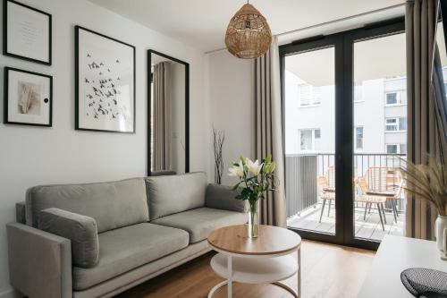 a living room with a couch and a table at Native Apartments Kościuszki 39I29 in Kraków