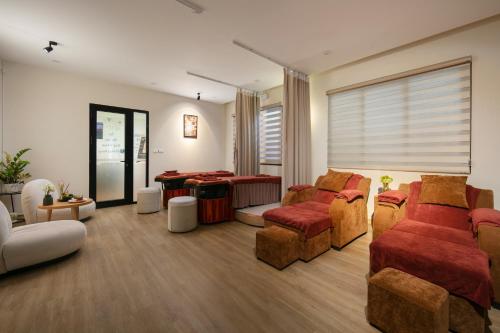 a living room with couches and chairs and a table at Westlake Pearl Suites & Spa 70 Xuan Dieu - By Pegasy Group in Hanoi
